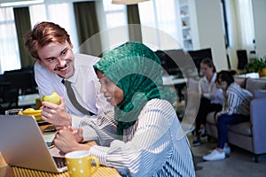 International multicultural business team working together on laptop