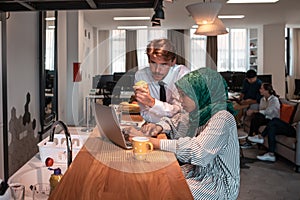 International multicultural business team.A young business man and woman sit in a modern relaxation space and talk about