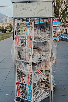 International newspapers on sale at a newspaper stand on a street in Nice, France