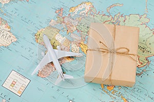International shipping. White model airplane land on the geographical map background photo