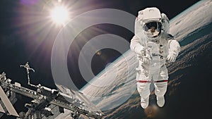 International Space Station and astronaut in outer space over the planet Earth. Elements of this image furnished by NASA