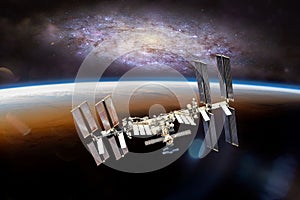 International space station on orbit of Earth planet. ISS with stars and galaxies. Elements of this image furnished by NASA