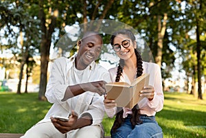 International students friends resting in university campus, studying with books and discussing classes outdoors