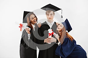 International students graduates rejoicing smiling posing over white background.
