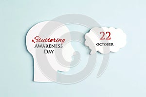 International Stuttering Awareness day, 22 October. Face profile silhouette with speech bubble on a blue background