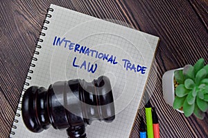 International Trade Law write on a book isolated on Wooden Table