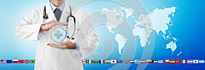 International travel medical insurance concept, doctor`s hands protect an shield cross icon, on blue background with