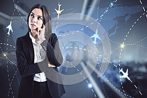 International traveling business concept with pensive businesswoman on digital screen background with plane icons connected by