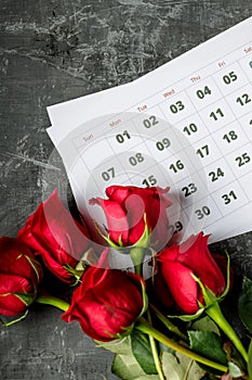 International Womans day concept with calendar pages of year 2021 of march and red roses on gray background