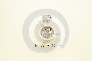 Two cups of coffee in the form of number 8, flat lay. International Women`s Day concept. 8 March