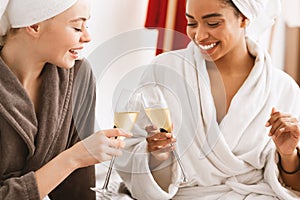 International women toasting with champagne, having spa day