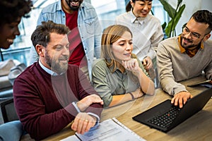 International workers group and team leader getting important news on their laptop