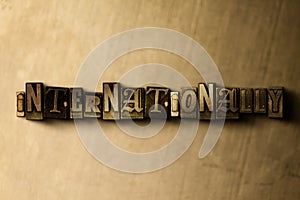 INTERNATIONALLY - close-up of grungy vintage typeset word on metal backdrop