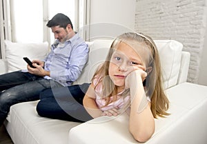 Internet addict father using mobile phone ignoring little sad daughter bored lonely and depressed