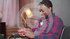 internet addiction and playing games in mobile application, joyful african man playing smartphone