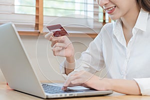 Internet banking, Online shopping at home, happy asian young woman, girl hand in holding credit card, using laptop computer,