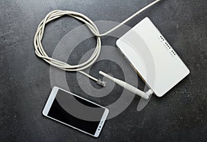 Internet cable with connector rj45, router to use wireless network and smartphone, on gray