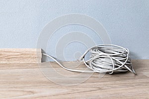 Internet cable RJ 45 in the baseboard along the gray wall in the room