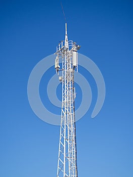 Internet and cell phone tower. Internet communications. Communication concept. White tower against the sky