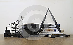 Internet connection with wlan router in home office. Wireless Routers for wi-fi internet. Stack of Wireless Routers. wire and