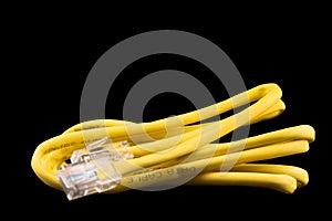 Internet data cable isolated on black background. Internet communication concept. Network internet yellow cable isolated over