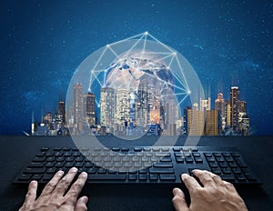 Internet, digital networking and connection. Hand typing computer keyboard and global network connection and the city. Element of