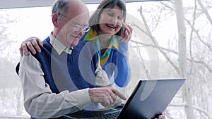 Internet entertainment, senior couple with laptop spend leisure time on vacation