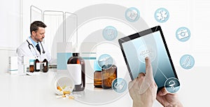 Internet healthcare and medical on mobile devices consultation, hand touch screen on digital tablet with symbols, doctor at desk