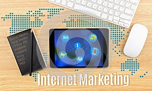 Internet Marketing word with tablet,keyboard and black notebook