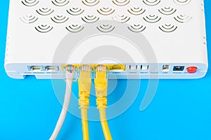 Internet modem router hub with a cable connecting on blue background