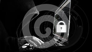 Internet network security system. Hacker in black hoodie using computer laptop
