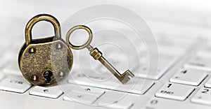 Internet privacy, web security concept, padlock and key on a white keyboard