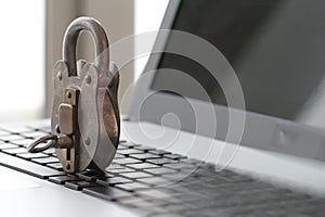 Internet security concept-old padlock and key on laptop computer