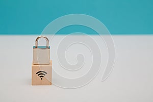 Internet security. Data safety. Wireless internet safeguard. Network under guard. Wooden cube, lock on top, wifi sign
