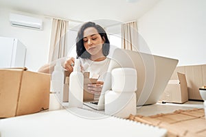 Internet shop employee packing items for shipping