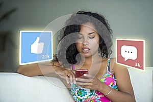 Internet social media app likes and chat comments icons composite on young beautiful and happy mixed ethnicity hispanic woman at