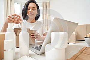 Internet store employee packing merchandise for shipping