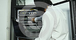 Internet technician checking modem cabinet.