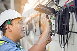 An internet technician is repairing or maintaining a fiber optic connection by opening a fiber optic connector