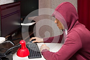 Internet troll using the computer. Bad and ugly man writing nasty things on the forum