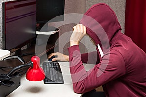 Internet troll using the computer. Bad man writing nasty things on the forum