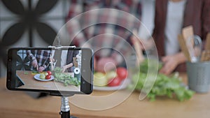 Internet videoblog, smartphone makes video for followers how bloggers man and woman cook preparing healthy meals from