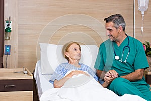 The internist asked about the illness and chat with the elderly woman in the recovery room photo