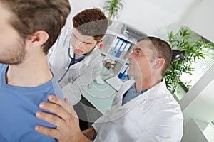 Internist doctor learning on job photo
