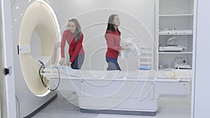 Interns prepare magnetic resonance imaging scanner for next procedure