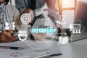 Business team working on digital tablet and financial data with internship icon on virtual screen