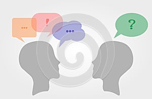 Interpersonal communication. Two heads representing people communicate through speech bubbles.