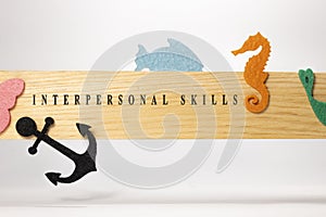 interpersonal skills written on a wooden patterned surface. Education and child psychology