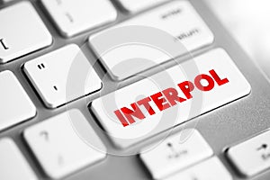 Interpol - international organization that facilitates worldwide police cooperation and crime control, text concept button on