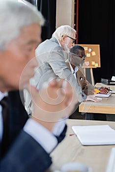 interracial businessmen working in office near